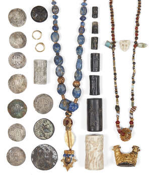 A restrung Western Asiatic necklace composed of agate and carnelian beads with two blue-green cylindrical beads pendant in an openwork gold pendant setting, wi