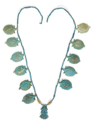An Egyptian blue glazed faience lotus flower necklace 
		Amarna Period, mid-14th Century B.C.
		Composed of twelve lotus flower amulets, each amulet of blue-