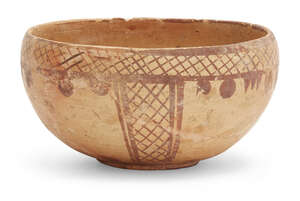 A small Neolithic buffware pottery bowl, Persia, 3rd millenium BC, of deep form, the exterior decorated in red with hatched bands to rim and panels to side, wi