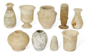 A group of Antiquities comprising four small Egyptian alabaster vessels
		Middle Kingdom-Ptolemaic Period, circa 1750-30 B.C., including a cylindrical-bodied 