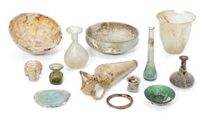 A group of glass vessels Hellenistic-Roman periods and Later, including a damaged Hellenistic amber glass mammiform bowl, 12.5cm diam; a damaged and restored m