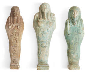 Three Egyptian glazed faience shabtis 
		Late Dynastic Period, circa 664-332 B.C.
		Each of typical mummiform holding pick and hoe, with a frontal column of 